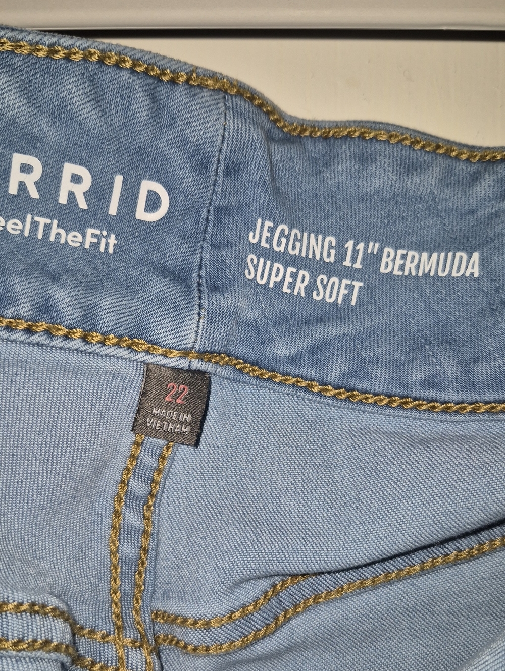 torrid Light Wash Denim Jegging Bermuda with Gold Stitching
